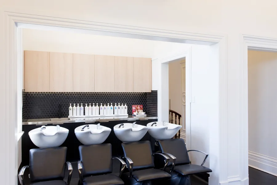 Cream Melbourne wash bay — four basins, black leather chairs